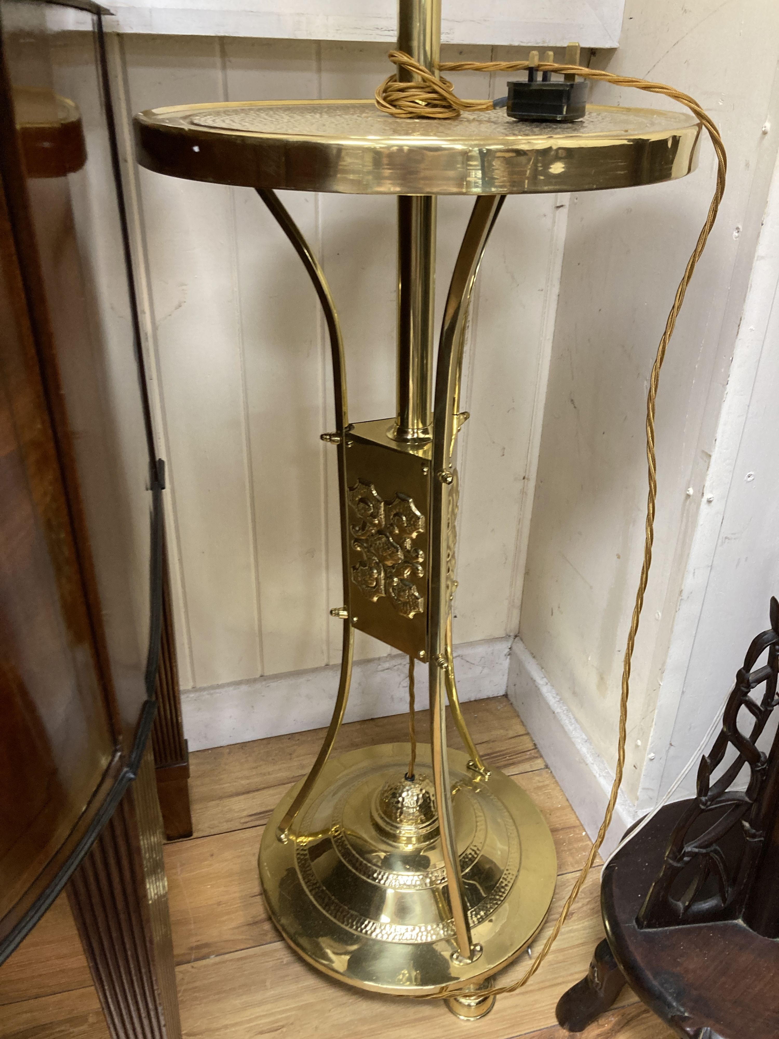 An early 20th century hammered brass standard lamp.